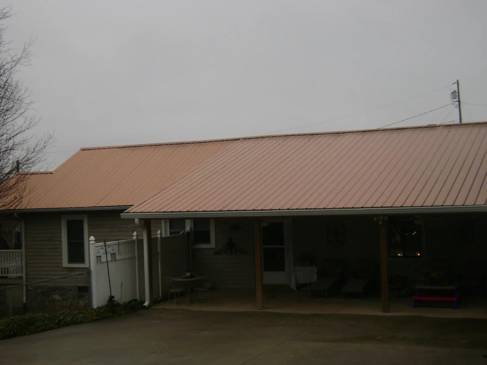 Copper toned metal roof over a wide covered patio in Prince George